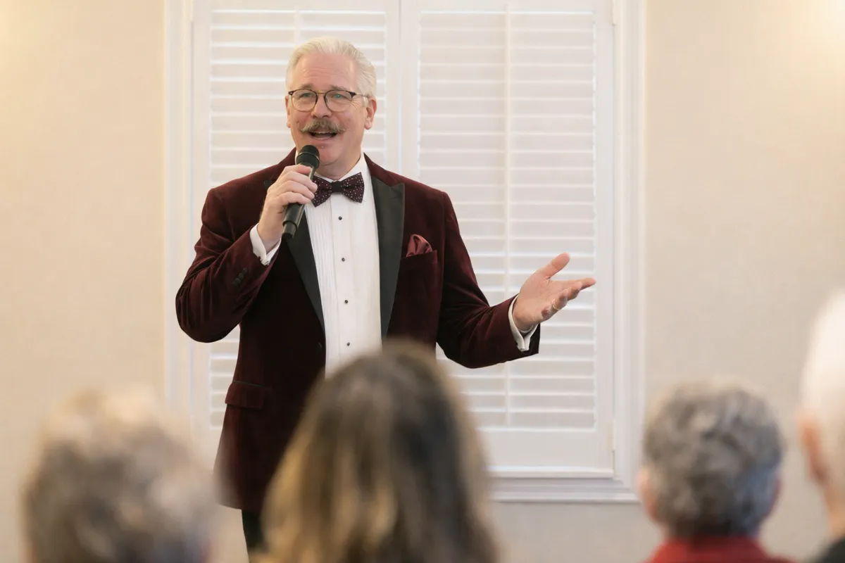 Ted speaking to an audience with a microphone